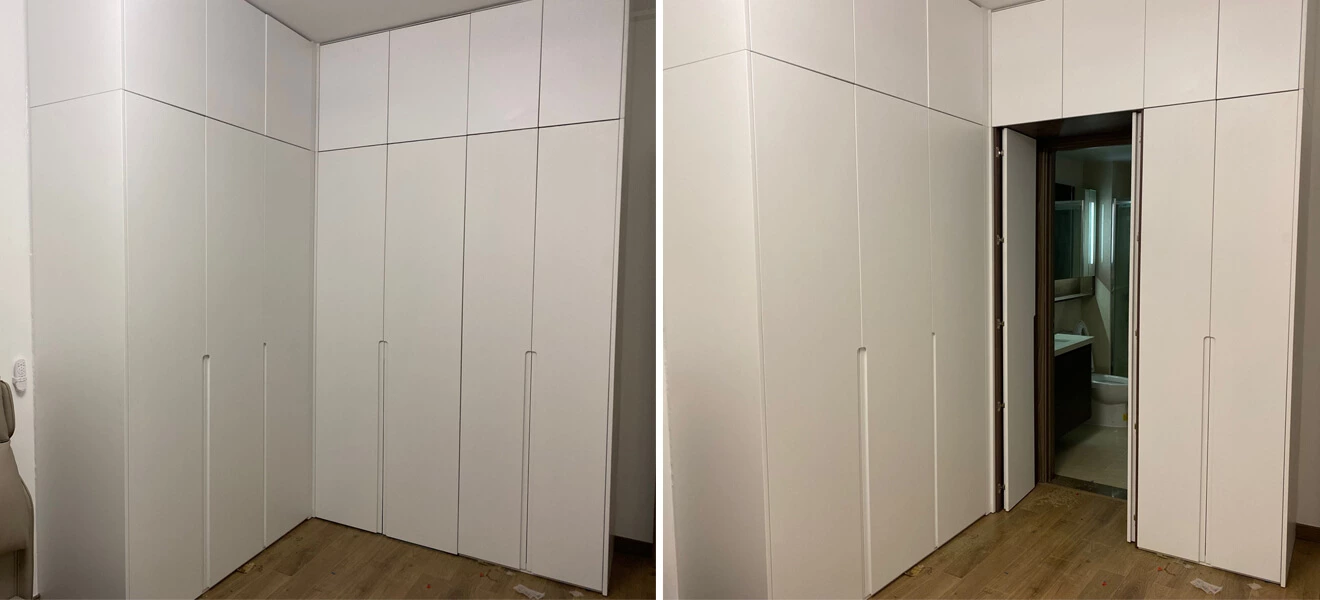 L-shaped fitted wardrobe with molded finger pulls and concealed door
