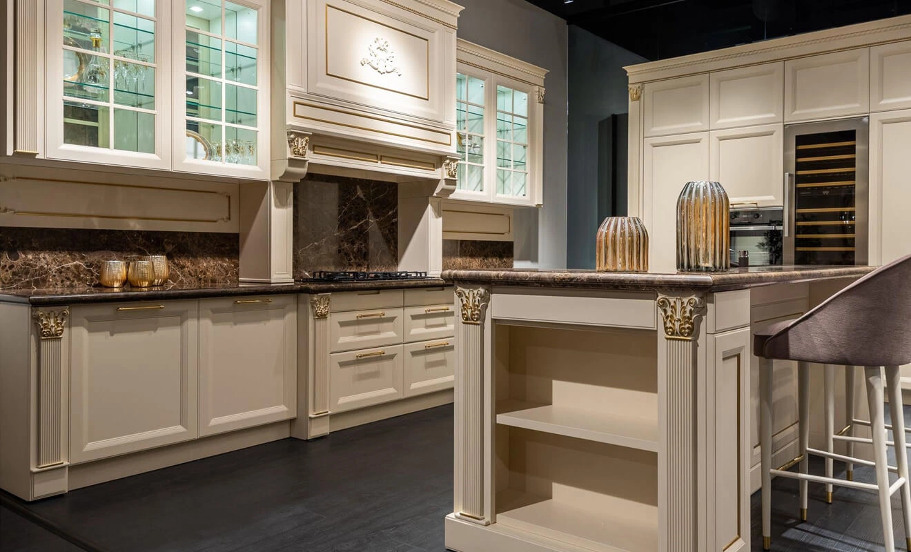 traditional white kitchen cabinets with molding and warm details