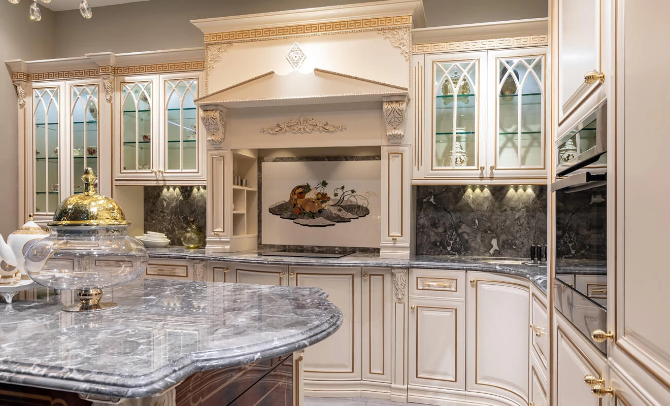 classic white kitchen cabinets with gold molding and decorative hardware