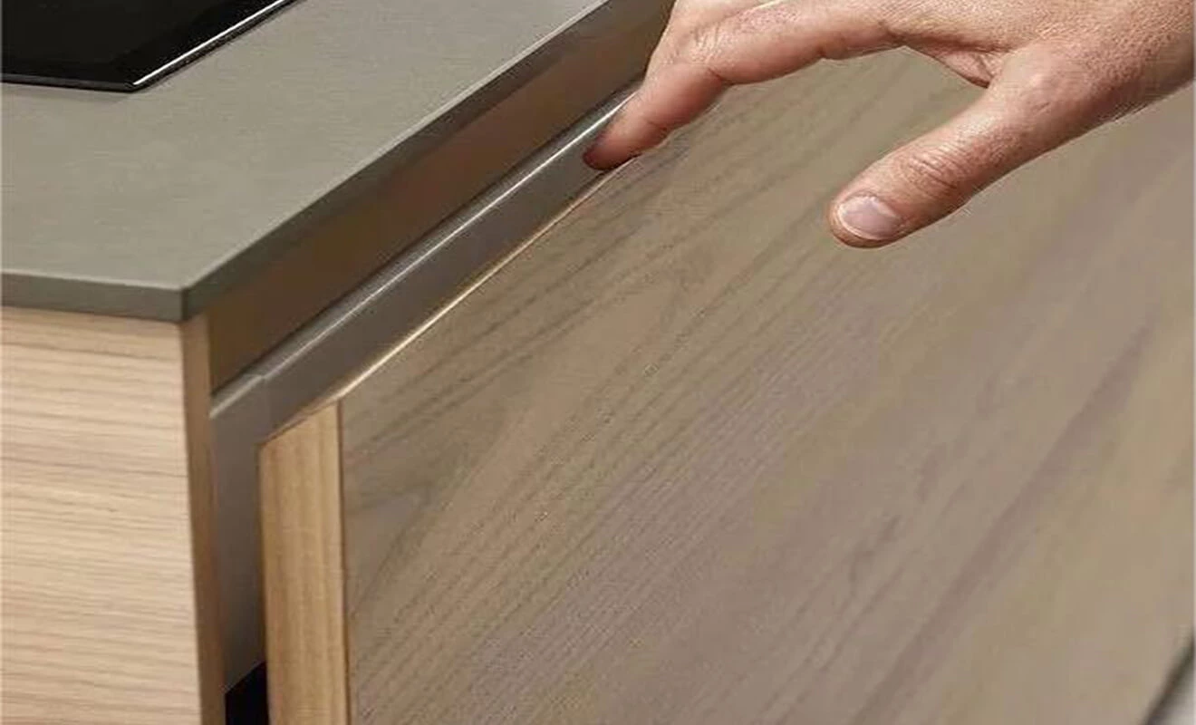Recessed slot handle for a seamless cabinet door Recessed slot handle for a seamless cabinet door