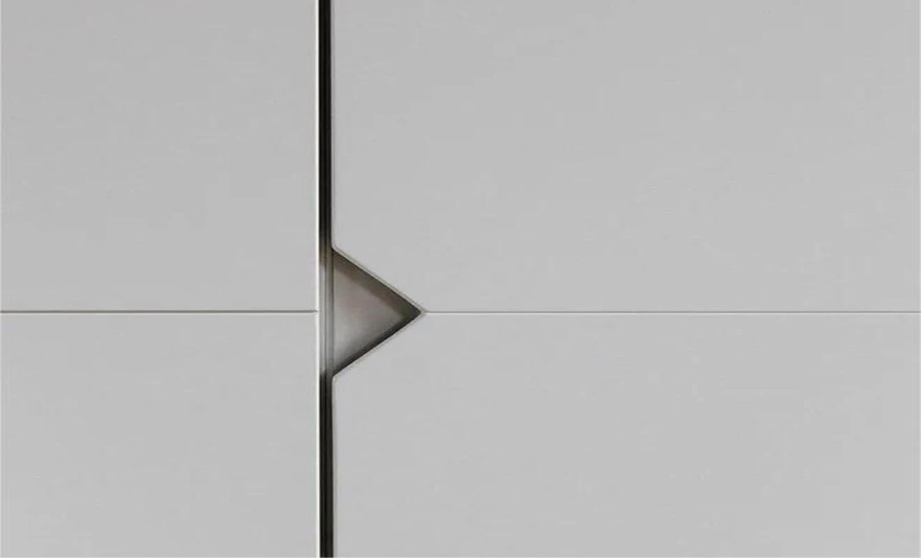 Corner-cut handle detail on an invisible cabinet door Corner-cut handle detail on an invisible cabinet door