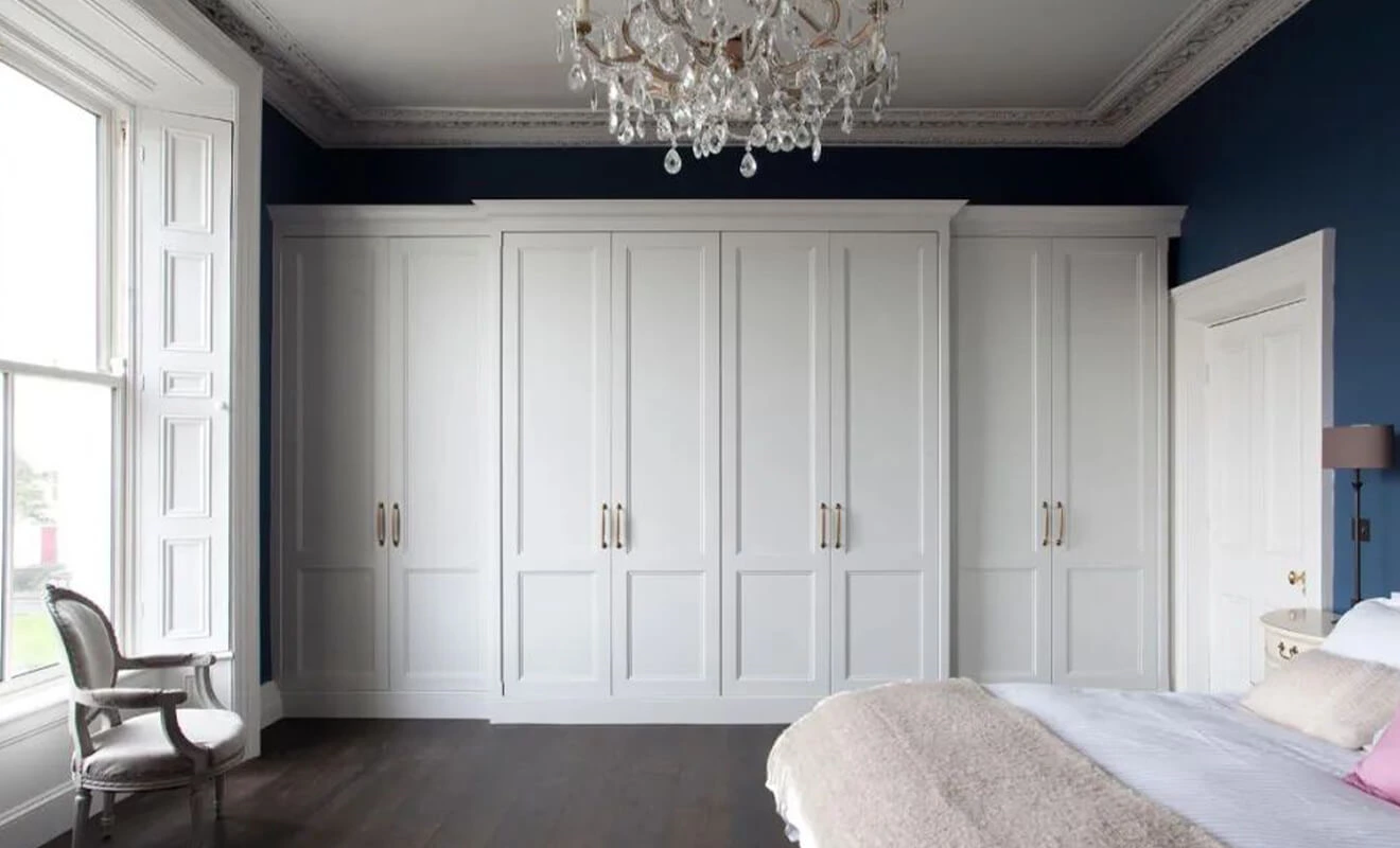Ceiling-height custom wardrobe design in a bedroom