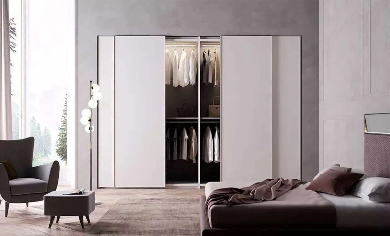 Floor-to-ceiling handleless wardrobe blended with the wall