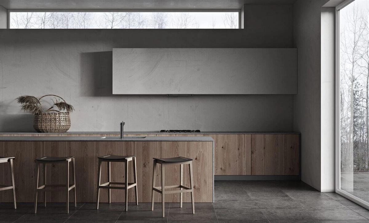 Grey kitchen cabinets with hardwood floor brass handles and white countertop