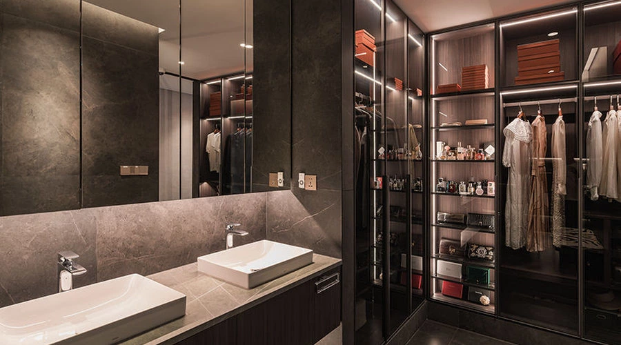 Bathroom closet suite with dark stone, walnut finishes and glass partitions