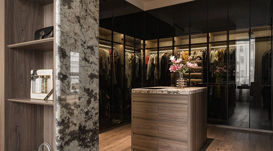 Connected walk-in closet with full-height mirror and integrated cabinetry