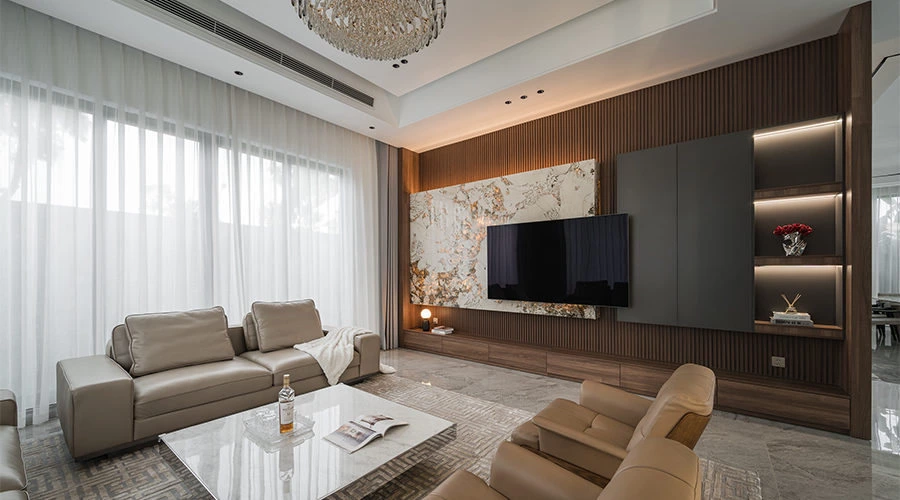 Symmetrical living room with a black and white natural stone TV feature wall