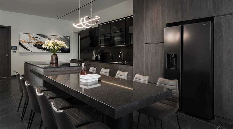 Dark quartz kitchen with full-height dark wood cabinetry