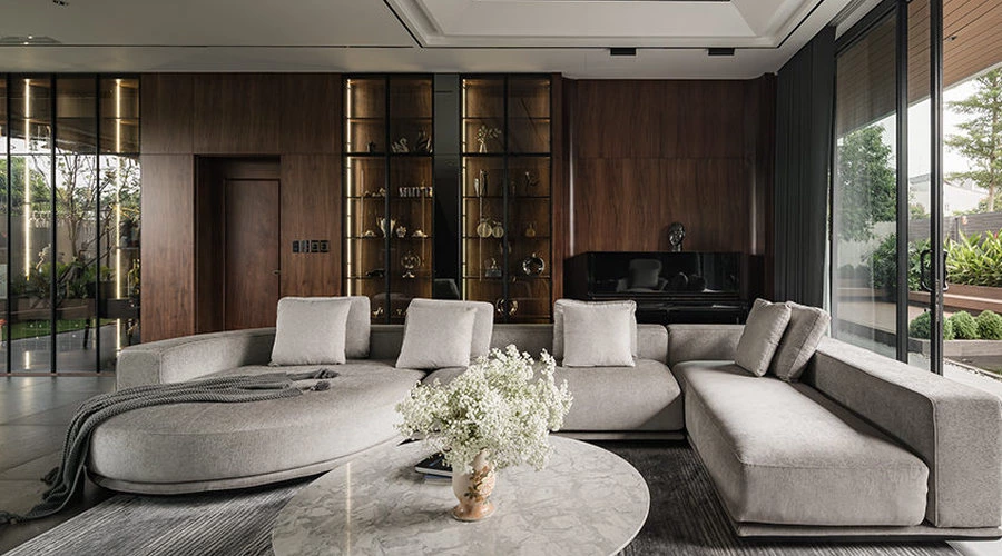 Integrated millwork display wall connecting open-plan living and dining areas