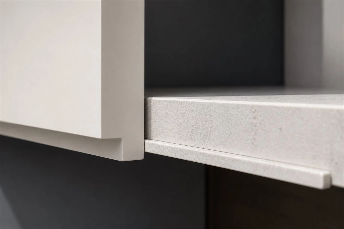 Extended edge pull handleless cabinet doors in a minimalist kitchen