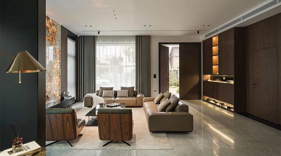Golden illuminated stone with walnut cabinetry and concealed living room storage