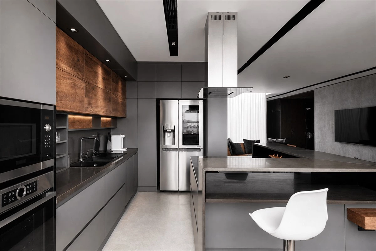 Grey apartment kitchen island with integrated storage and bartop