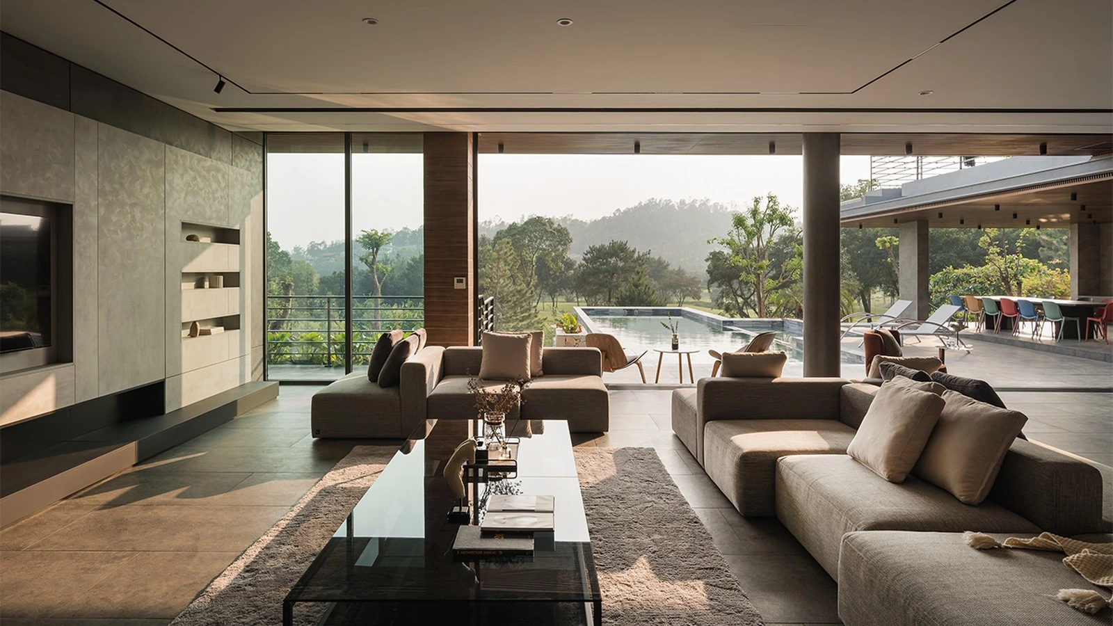 Open living and dining area connected to a mountain view and pool