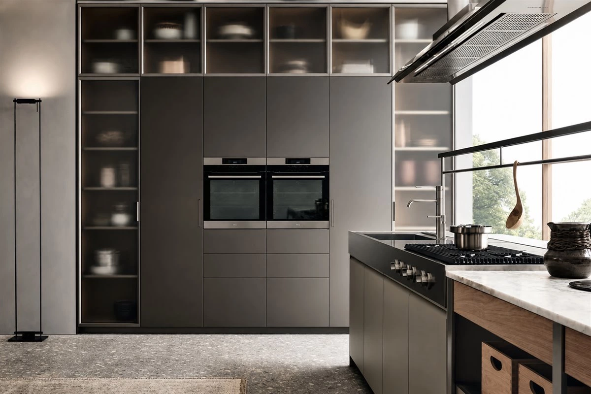 Open-Plan Stainless Steel Kitchen With Island Open-plan kitchen with glass cabinets, stainless steel accents and island