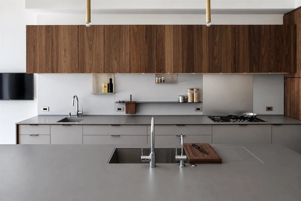 Galley kitchen with wood cabinets and stainless steel Galley kitchen with wood cabinets stainless steel details and practical storage