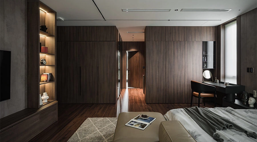 Walnut master bedroom wardrobe and black vanity area