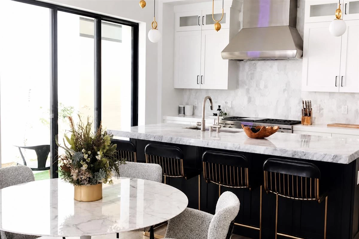 Black kitchen cabinets with brass hardware and gold accents