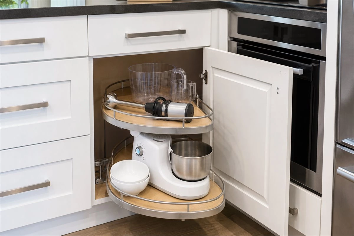 Corner base cabinet storage solution with rotating kitchen shelves