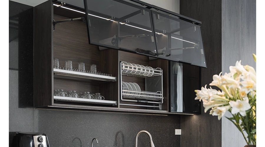 Black aluminum framed glass cabinet in a dark quartz kitchen
