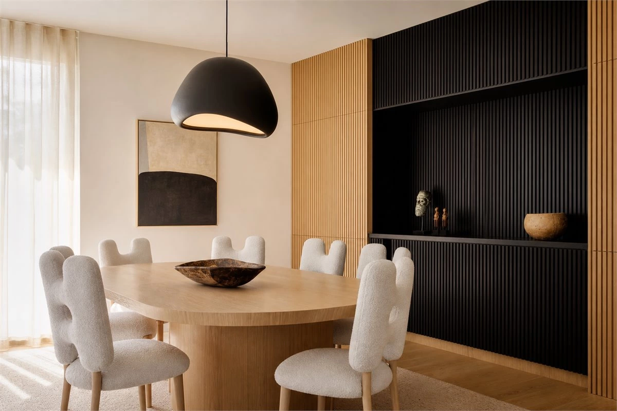 Oversized pendant light and statement decor in a modern living room