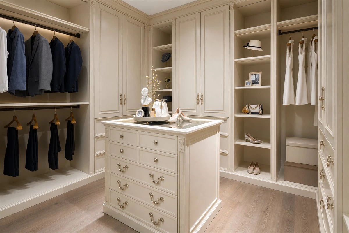 Pearl white walk-in dressing room with central island Pearl white walk-in dressing room with wardrobe island and display storage
