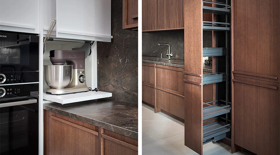 Integrated lighting and walnut cabinetry detail in a walnut white kitchen