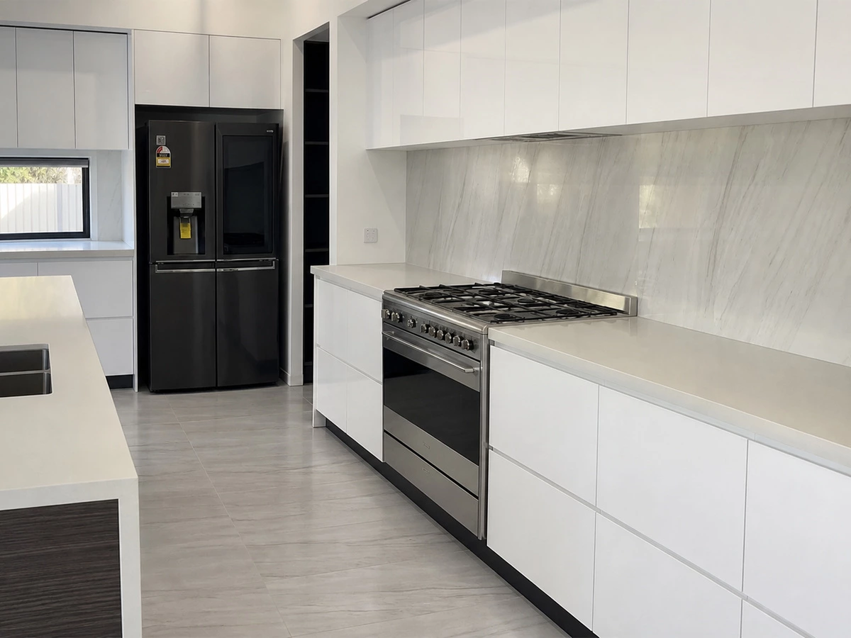 White kitchen units with organized drawer storage and a functional island layout
