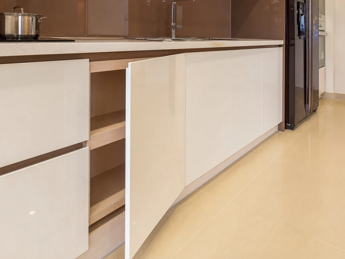 Plywood cabinet box detail behind white lacquer kitchen cabinet doors