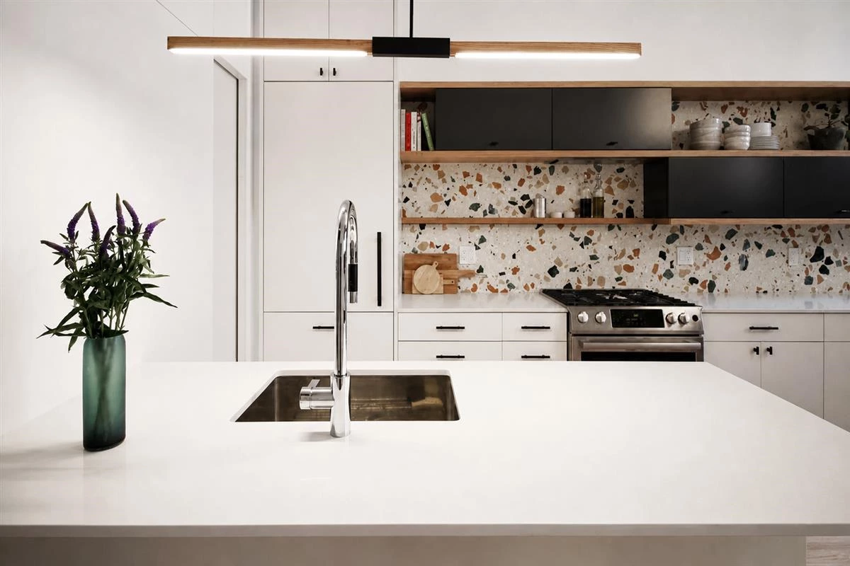 Black kitchen island with terrazzo details
