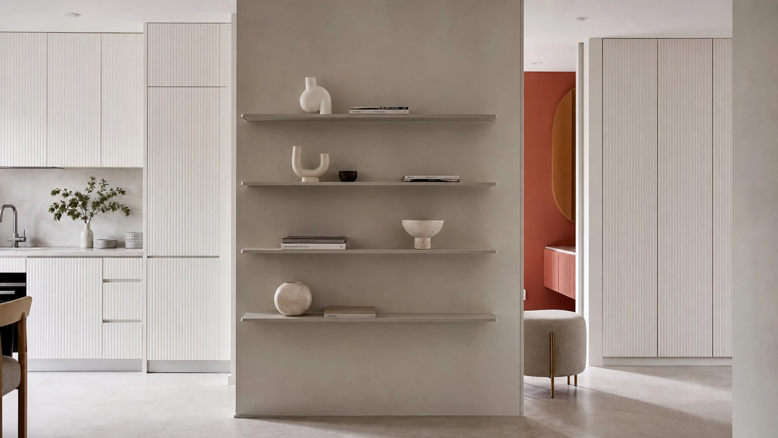 L-shaped kitchen cabinetry with grey sections and a coral pink backdrop