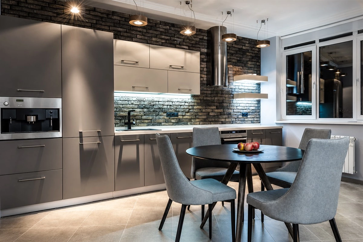 Modern grey kitchen with terrazzo countertop and layered grey cabinets