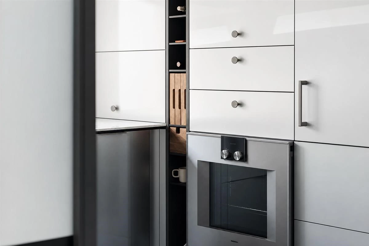 Narrow pull-out spice rack in a custom kitchen cabinet gap