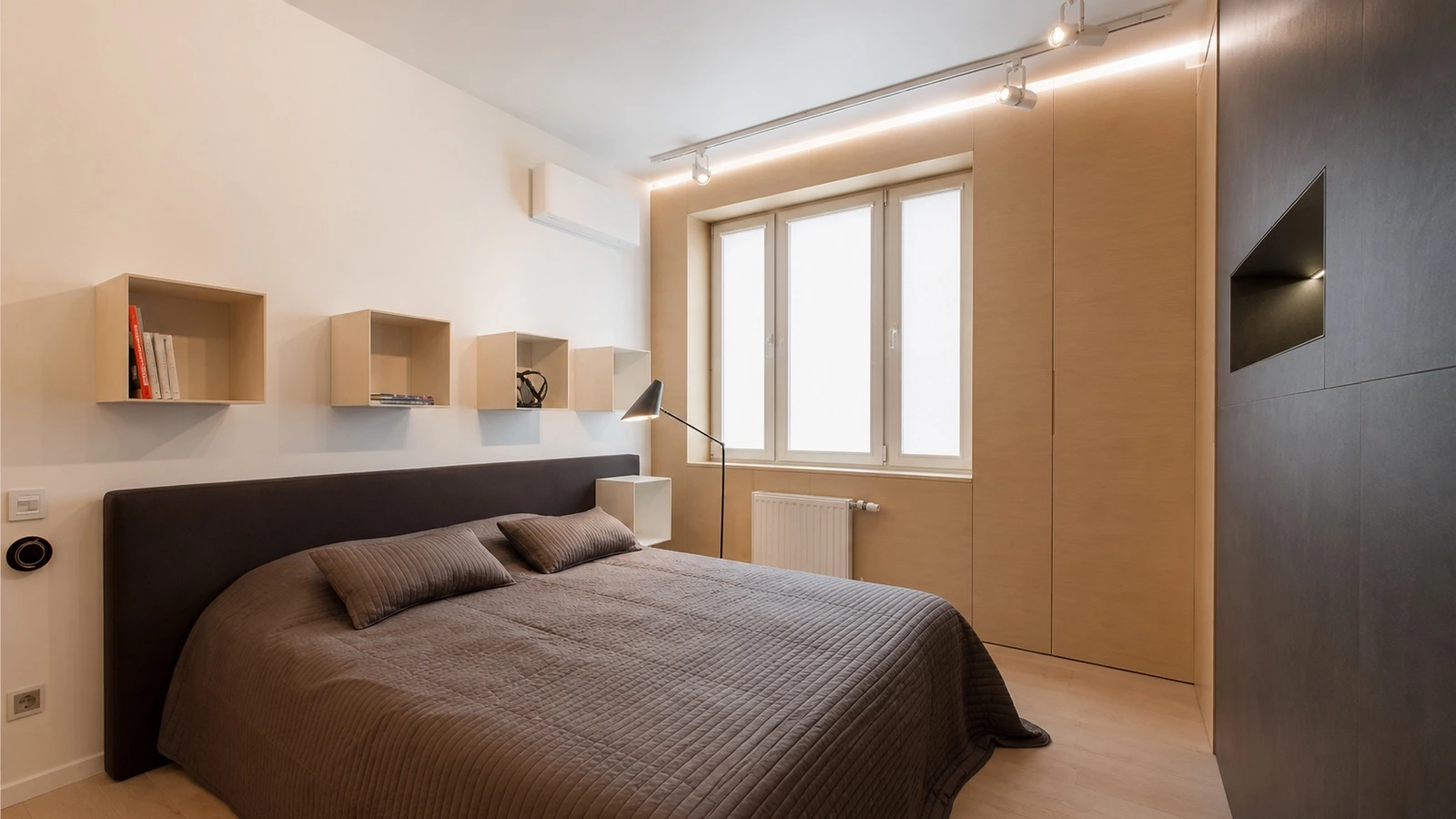 Open bedside storage cabinet in a small apartment bedroom