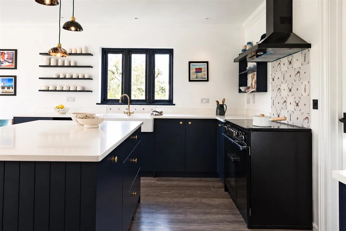 Black lower kitchen cabinets in a bright airy kitchen