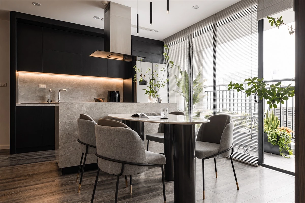 Black wood apartment kitchen cabinets with a quartz island