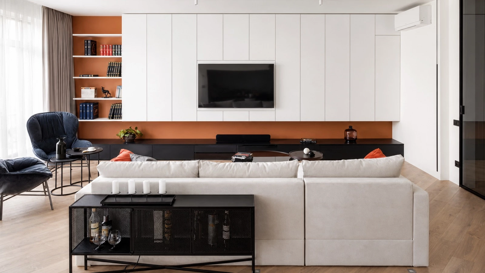 Colorful cabinetry coordinated with a living room TV cabinet in a New York home