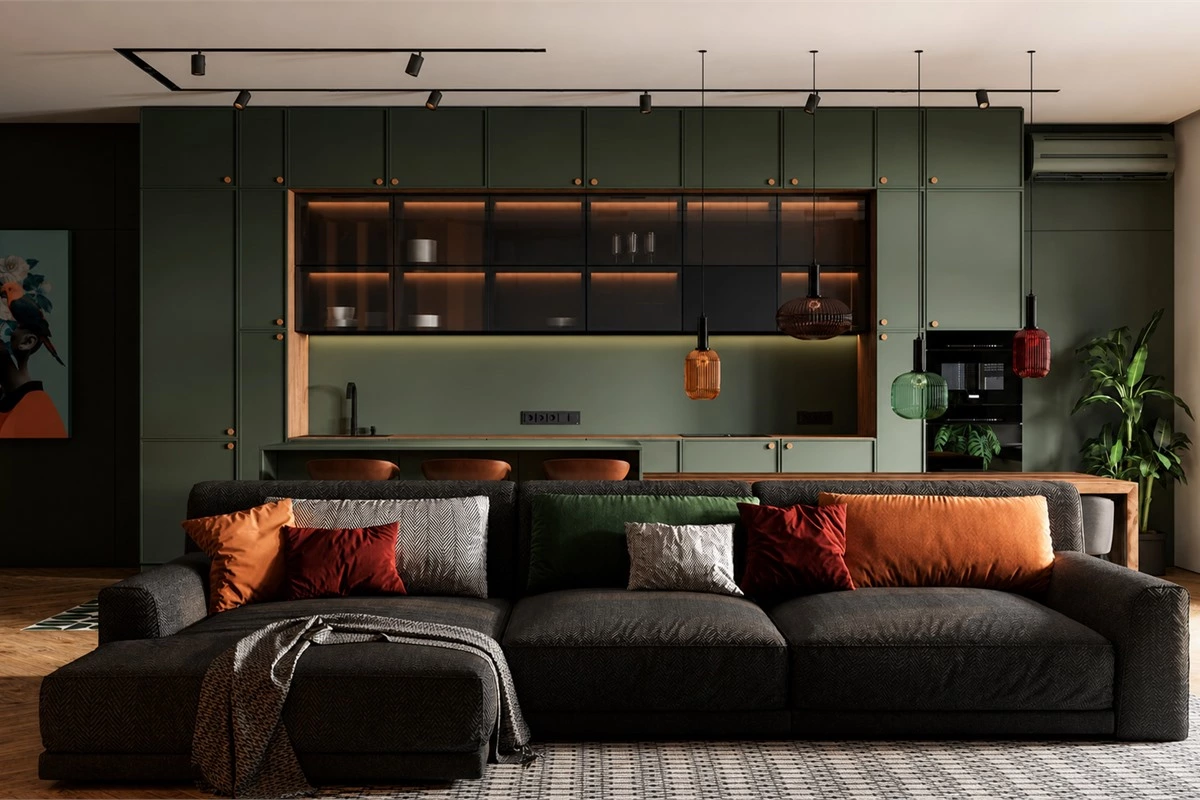Dark green kitchen cabinets with brass handles, glass wall cabinets and warm wood countertop