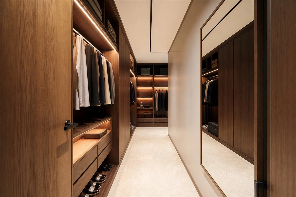 Full-height mirror in a narrow modern walk-in closet