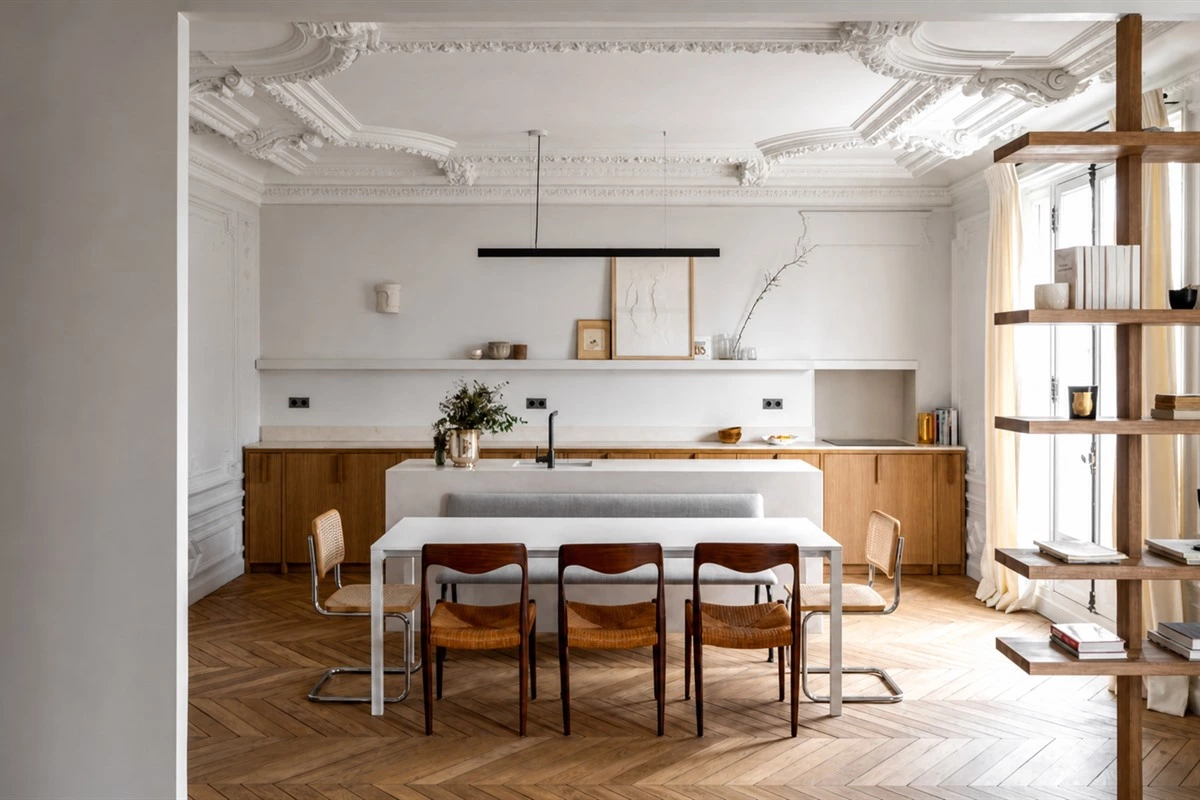 Parisian minimalist kitchen with warm wood cabinetry and marble island