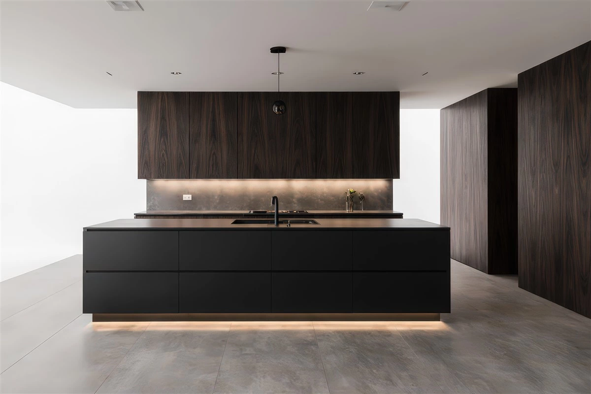 Timber upper cabinets with black base cabinets in a modern kitchen