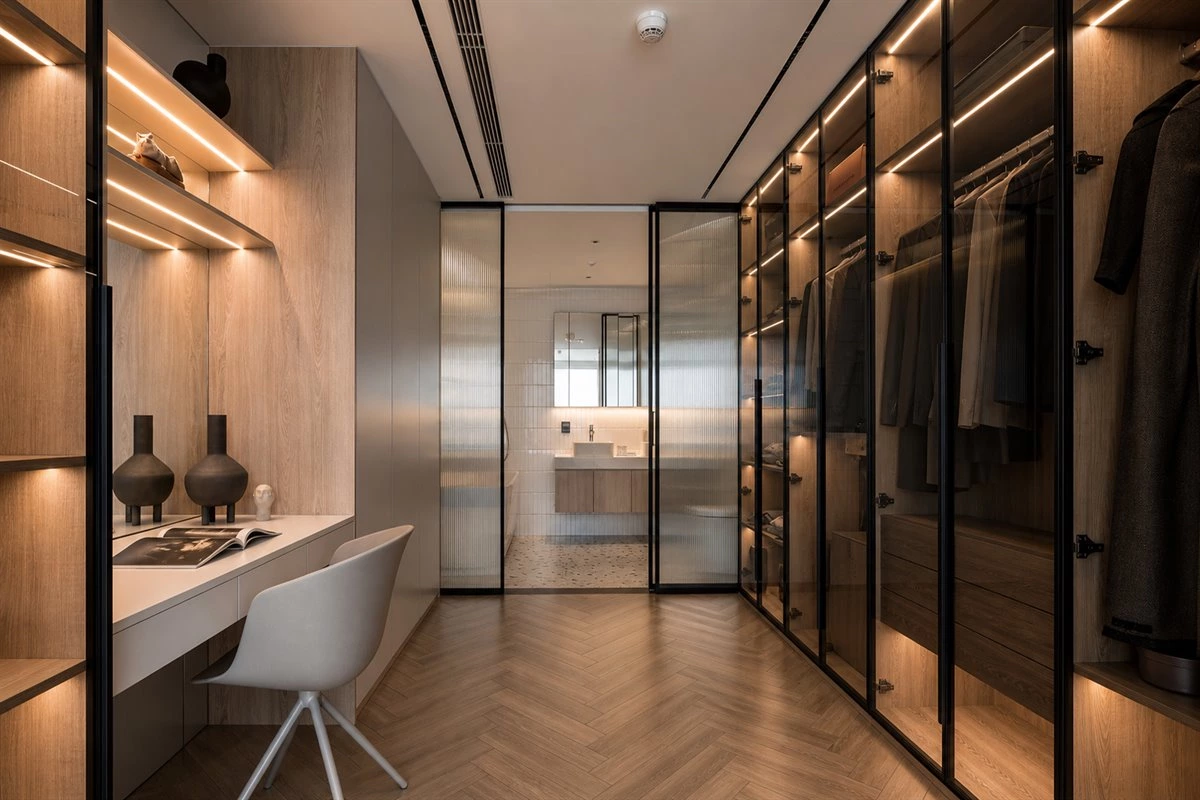 Versatile galley walk-in closet with glass wardrobe dresser open shelves and recessed lights