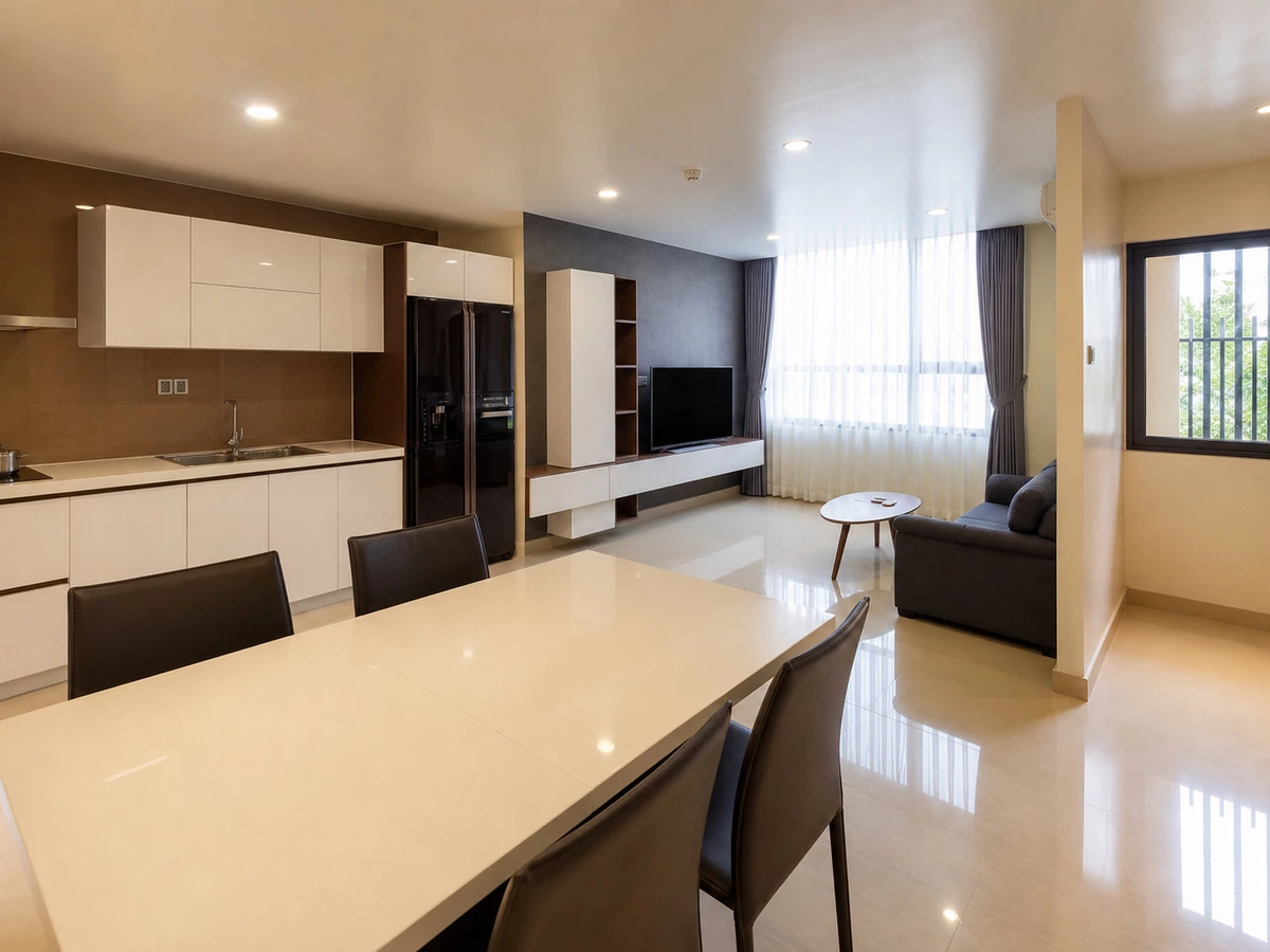 Overview of coordinated kitchen and living cabinetry in the Ho Chi Minh apartment project