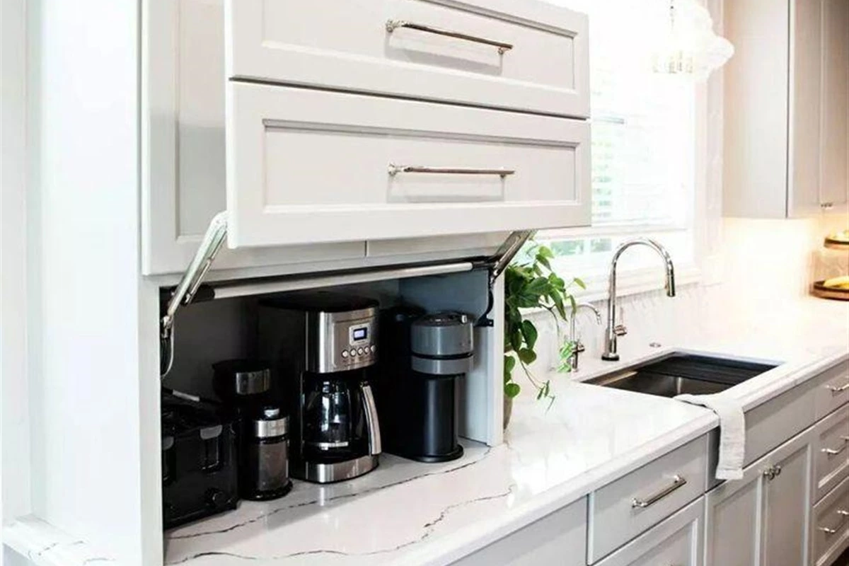 Hidden kitchen appliance garage with coffee machine and storage