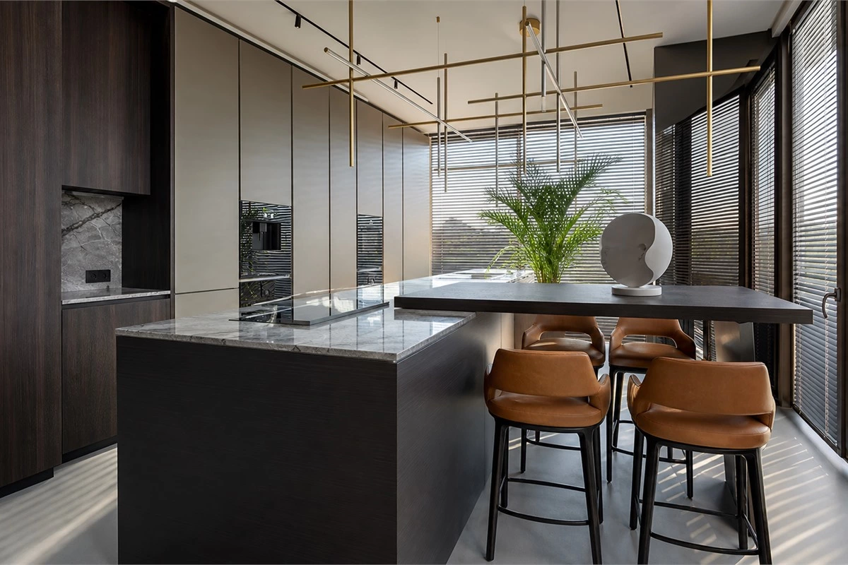Industrial style eat-in kitchen with dark wood storage, marble island and extended wood bar