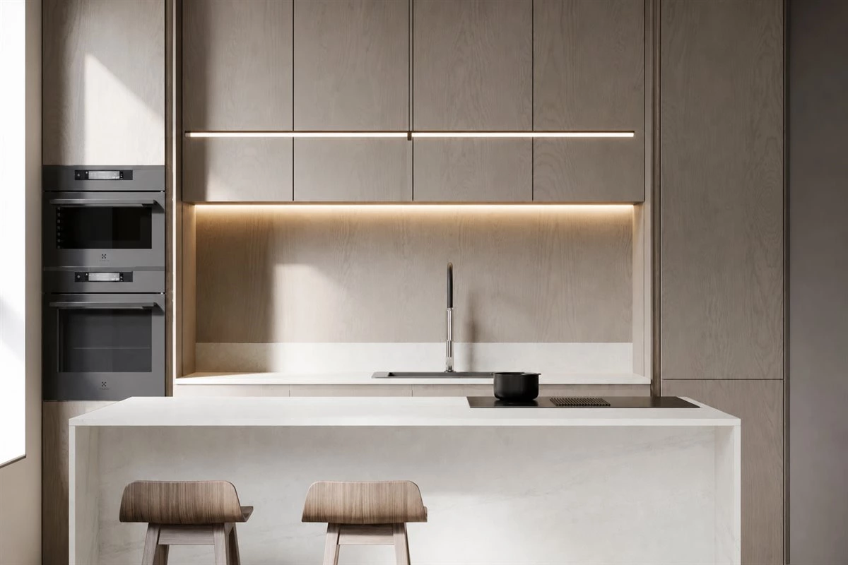 White modern kitchen island with induction cooktop White modern kitchen island with integrated induction cooktop and wooden bar stools