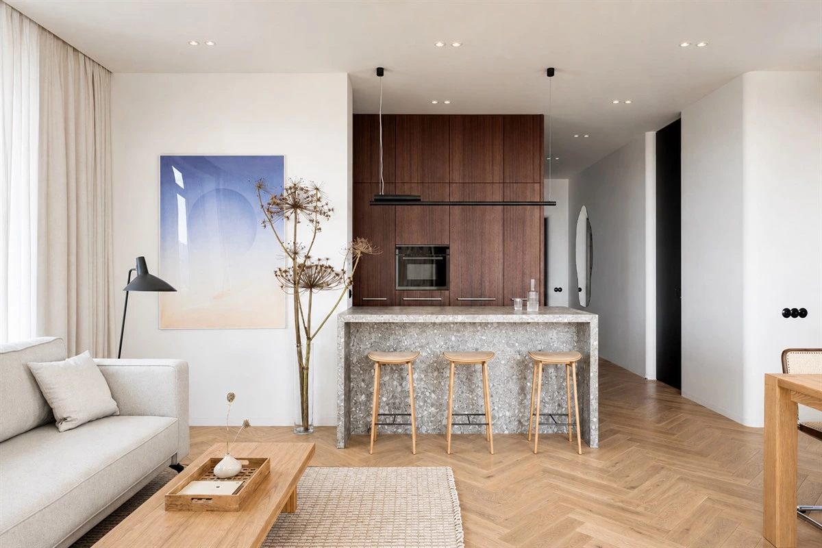 Wood and stone peninsula in a compact modern apartment kitchen
