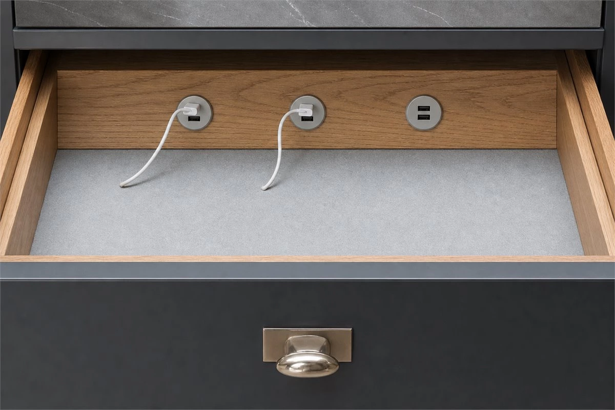 Concealed kitchen power outlets installed below a countertop