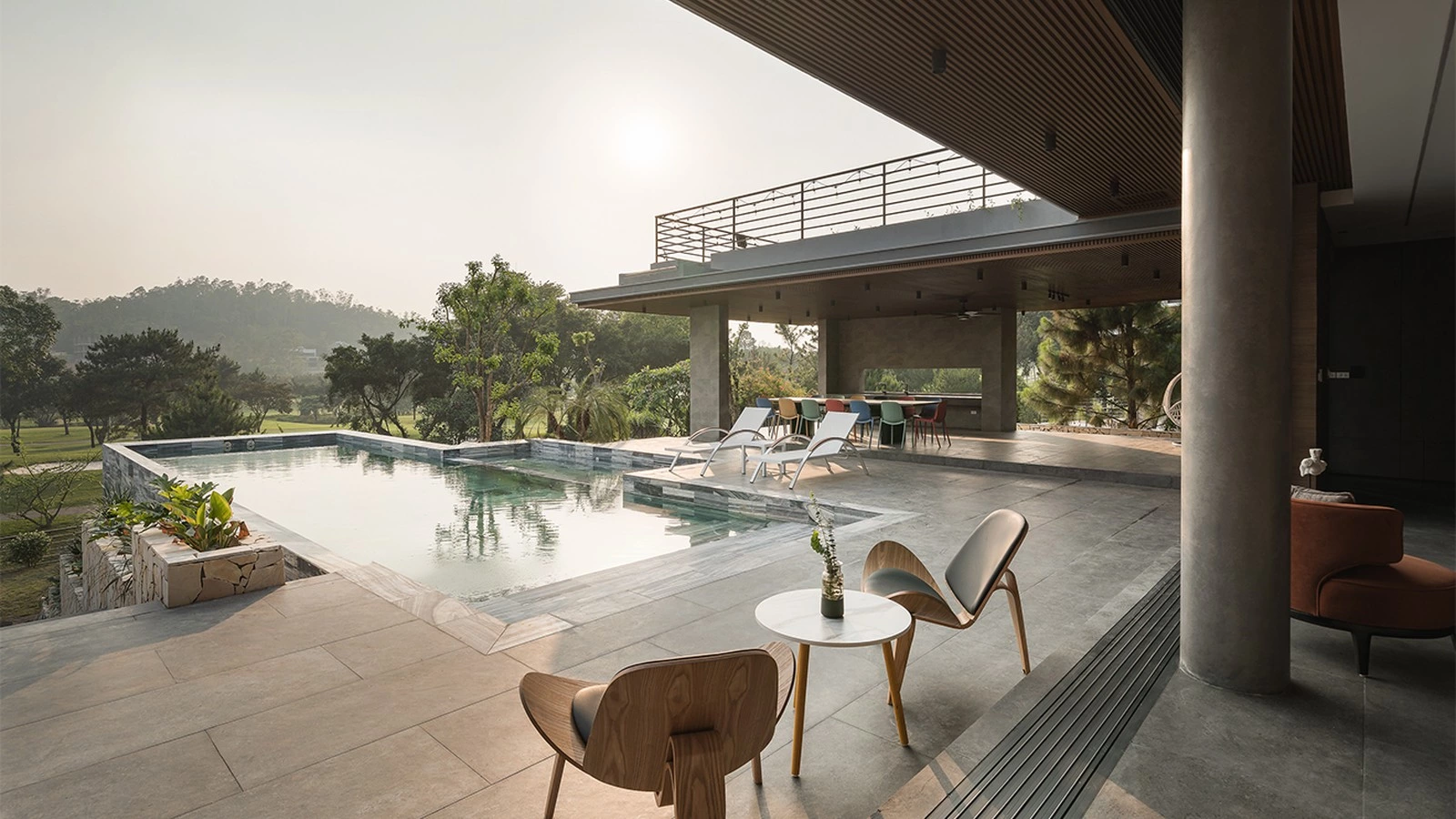 Indoor-outdoor transition with glass doors, pool and mountain view