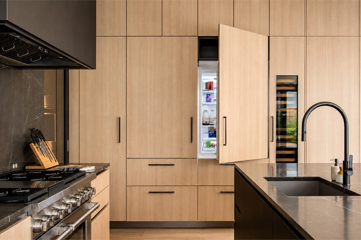 Minimalist kitchen work area with pull-out storage accessible drawers and clear countertop