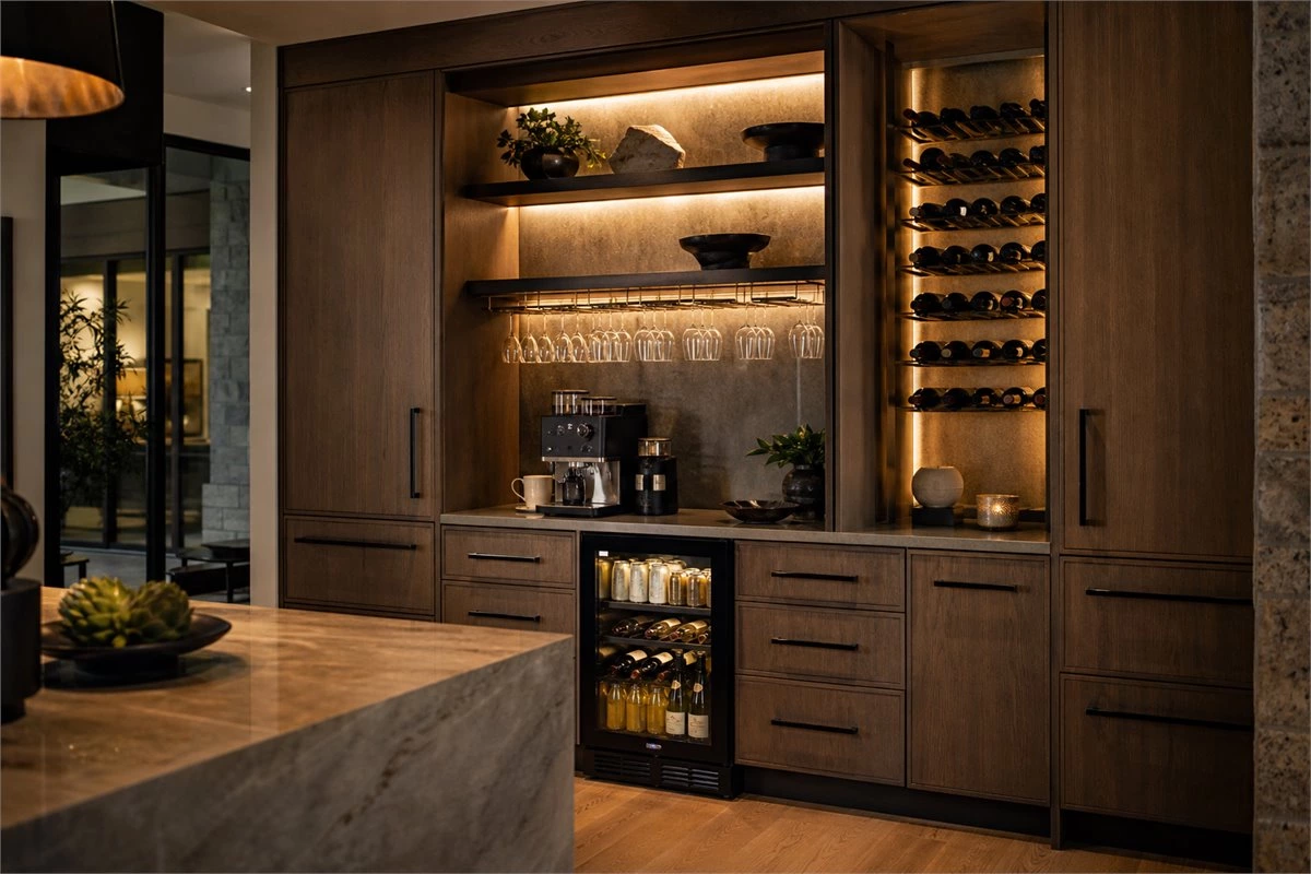 Kitchen coffee bar and wine storage with custom cabinets, glass holders, and countertop space